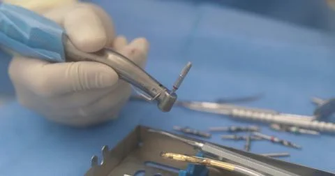 Doctor's hands with a working tool. Preparation and process of dental treat.. Stock Photos