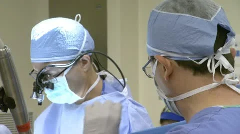 Doctors With Headgear Close up While Performing Surgery Stock Footage 20959489