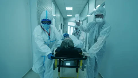 Doctors help a man with coronavirus, transferring him on stretcher. Coronavirus Stock Footage 135436168
