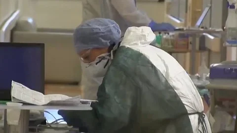 Doctors at the Hospital in masks and costumes. People in line. Quarantine in Ita Stock Footage
