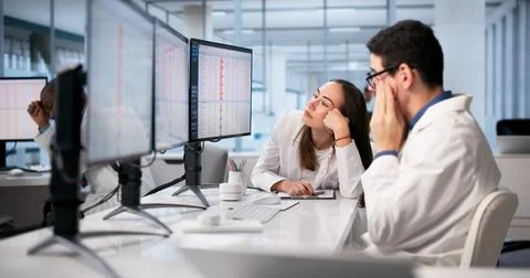 Doctors In Hospital Using Spreadsheets And Medical Codes, Feeling Stressed. Stock-Fotos