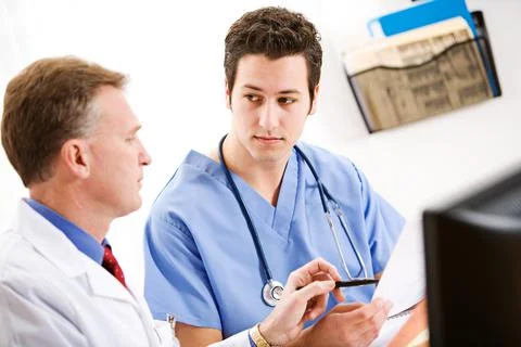 Doctors: Intern Learns from Doctor Stock Photos
