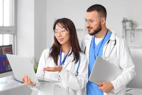 Doctors with laptops analyzing scientific data in laboratory Stock Photos