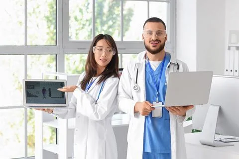 Doctors with laptops analyzing scientific data in laboratory Stock Photos