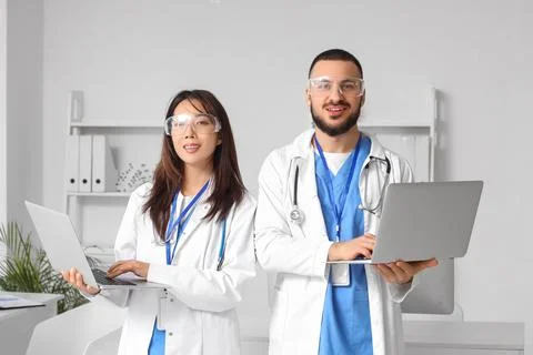 Doctors with laptops analyzing scientific data in laboratory Stock Photos