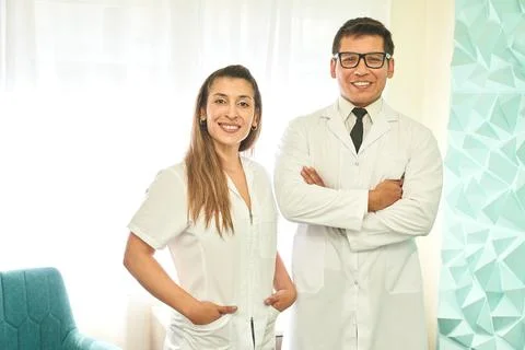 Doctors looking at the camera with pride in the clinic Stock Photos