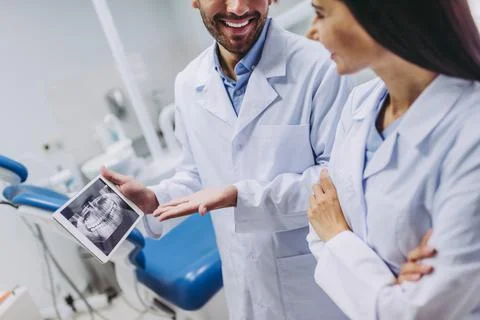 Doctors looking at digital tablet screen with x-ray Stock Photos