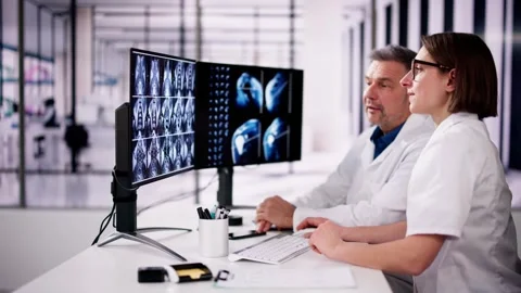 Doctors Looking At An MRI Scan At Computer Stock Footage 269474855