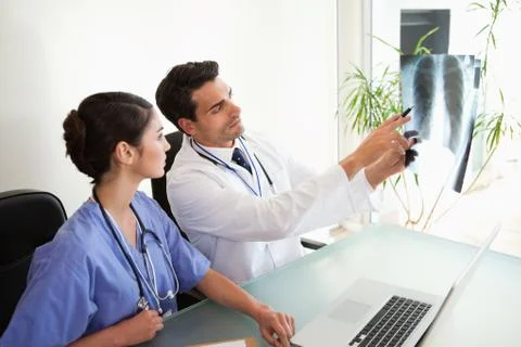Doctors looking at a set of X-ray Stock Photos