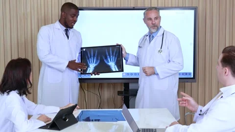 Doctors looking at x ray image Stock Footage 245821195
