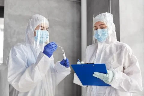 Doctors in medical mask and shield with clipboard Stock Photos