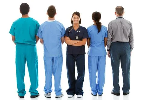 Doctors: nurse faces to camera with others turned Stock Photos