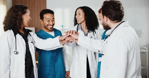 Doctors, nurses and hands together in hospital for healthcare, teamwork or Stock Photos