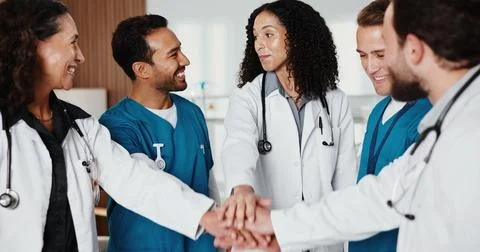 Doctors, nurses and hands together in clinic for healthcare, teamwork or support Stock Photos