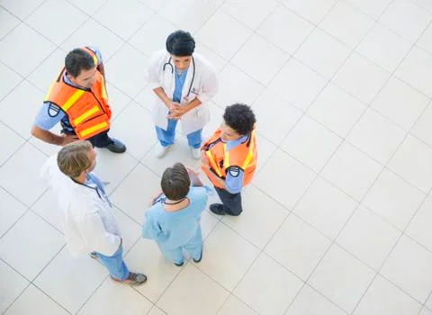Doctors, nurses, and paramedics talking in hospital Stock Photos