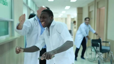Doctors, nurses and patients jump dancing in the hospital Stock Footage 173744659