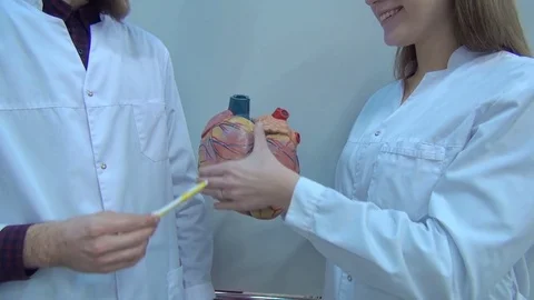 Doctors, nurses and surgeons in group meeting. A touch screen device is central Stock Footage 74227599