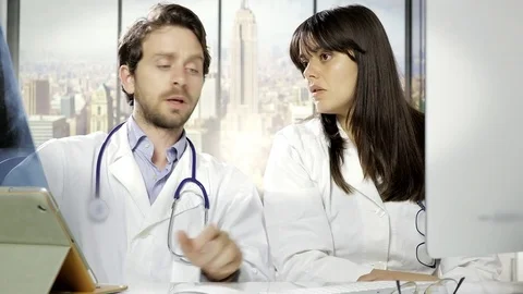 Doctors in office checking xray results working with pc Stock Footage 75911543