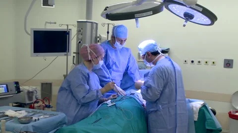 Doctors operating in operating room Stock Footage 43052068