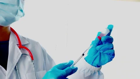Doctors or scientists are carrying syringes with liquid vaccines for young and o Stock Footage 146072717