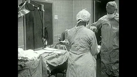 Doctors perform open-heart surgery on a child during the 1950s Stock Footage 102175622