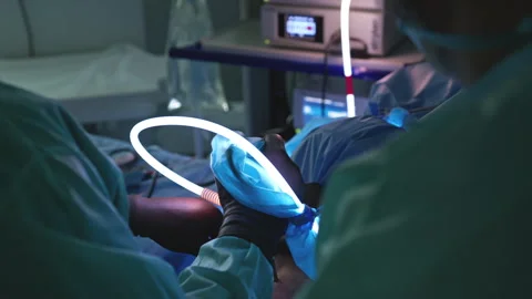 Doctors Performing Complex Surgery Using Advanced Medical Equipment in a Ste 動画素材 296929837