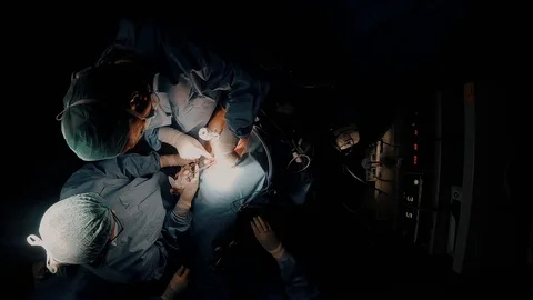 Doctors performing surgery Stock Footage 105819279