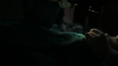 Doctors performing surgery in operating theatre Stock Footage 62924098