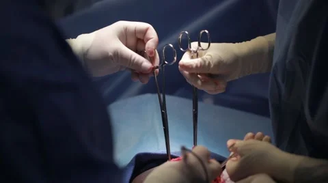 Doctors performing surgery on a patient Stock Footage 62389019
