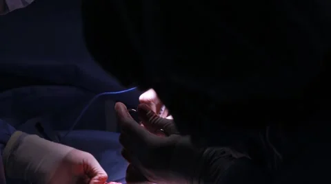Doctors performing surgery on a patient Stock Footage 62389050