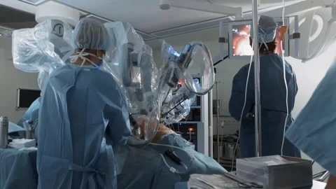 Doctors performs surgery using medical robot in modern clinic operating room Stock Footage 241228183