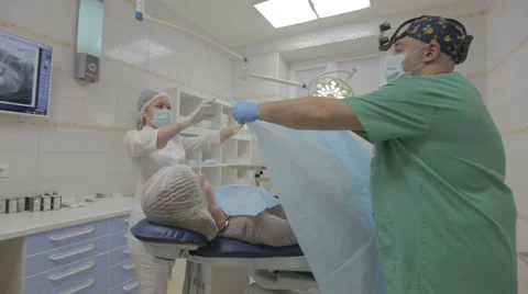 Doctors preparing patient for surgery Stock Footage 61378162