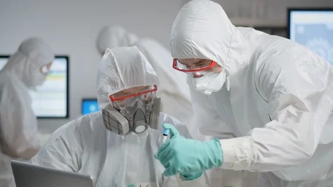 Doctors in protective clothes working on virus vaccine Stock Footage 127504934