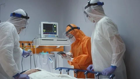 Doctors in Protective Suits Consult Coronavirus Patient's Status Stock-Footage 126032575