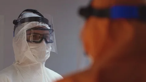 Doctors in Protective Suits Consult Coronavirus Patient's Status Stock-Footage 126205044