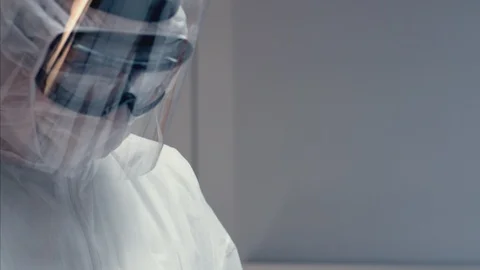 Doctors in Protective Suits Consult Coronavirus Patient's Status - Close Up Stock Footage 126205157
