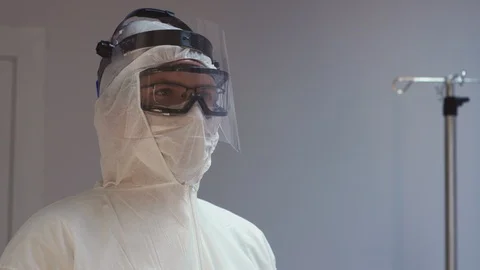 Doctors in Protective Suits Consult Coronavirus Patient's Status Stock Footage 126205468