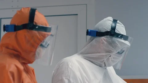 Doctors in Protective Suits Consult Coronavirus Patient's Status Stock-Footage 126205645