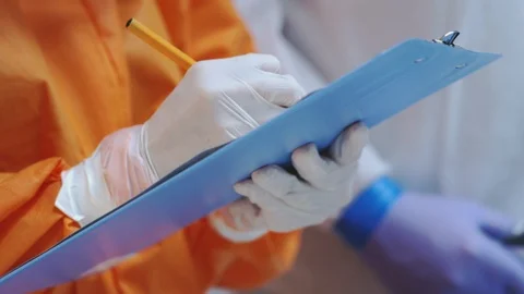 Doctors in Protective Suits Consult Coronavirus Patient's Status Stock Footage 126205928