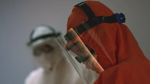 Doctors in Protective Suits Consult Coronavirus Patient's Status Stock-Footage 126206407