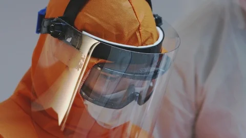 Doctors in Protective Suits Consult Coronavirus Patient's Status Stock-Footage 126206536