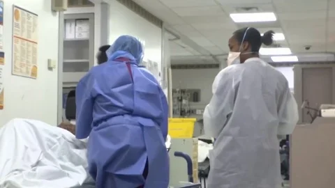 Doctors in Protective Suits Examine Patients. Quarantine in Italy. Covid 19 Video stock 128258301