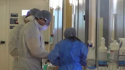 Doctors in protective suits. Laboratory. Quarantine in the USA. Covid 19 Stock Footage 128258516