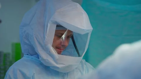 Doctors in protective uniform. Surgeon perform a surgery Stock Footage 135399820