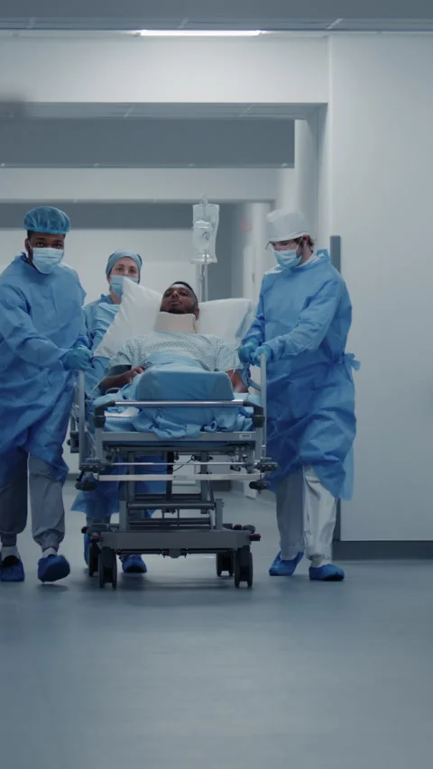 Doctors push stretcher with man to surgery room Stock Footage 275237562