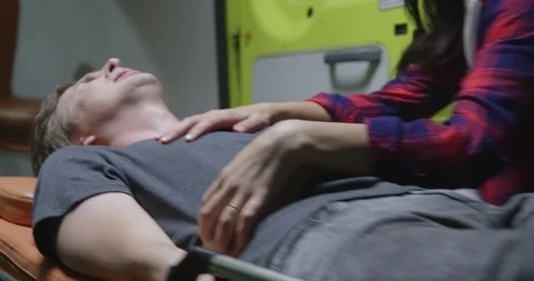 Doctors put the man in the ambulance. Stock Footage 116671374