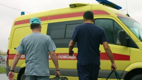 Doctors rush to the ambulance car Stock Footage 101011422