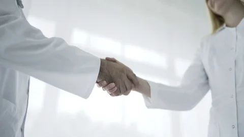 Doctors is shaking hands to each other Stock Footage 77876745