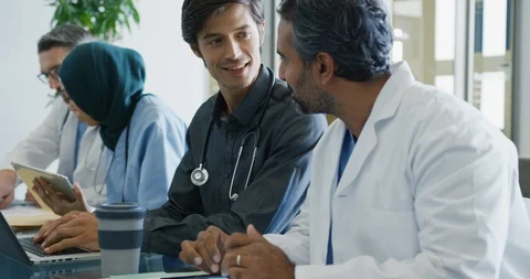Doctors sit working together at a table 4k Stock-Footage 112027801