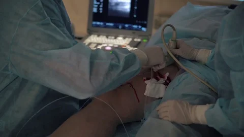 Doctors surgeons do surgery on the leg with special equipment in the operating Stock Footage 126746527